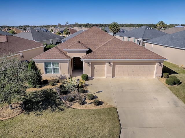 view of front of home featuring a front lawn and a garage