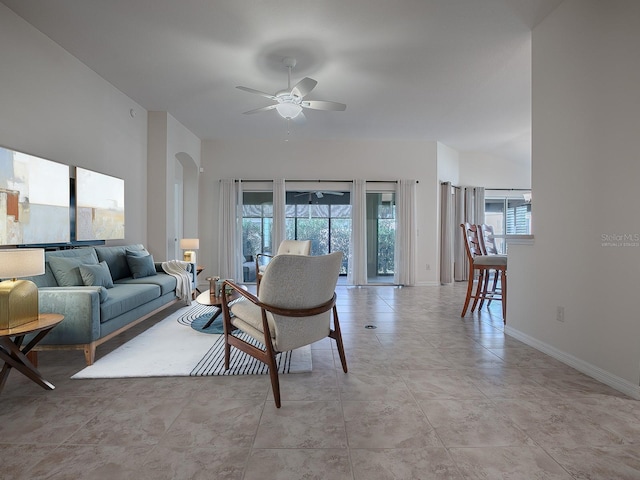 tiled living room featuring ceiling fan