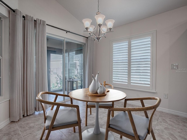 dining space featuring a wealth of natural light, lofted ceiling, and a notable chandelier