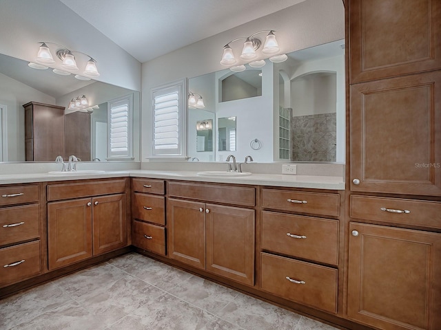 bathroom featuring lofted ceiling and vanity