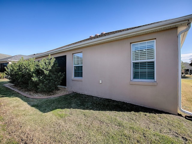 view of property exterior with a lawn