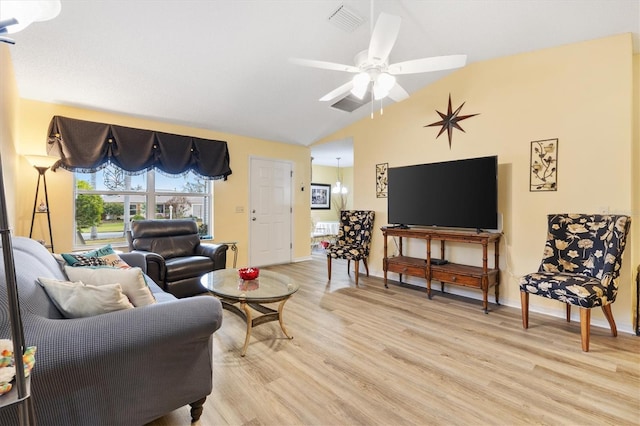 living room with ceiling fan, light hardwood / wood-style flooring, and lofted ceiling