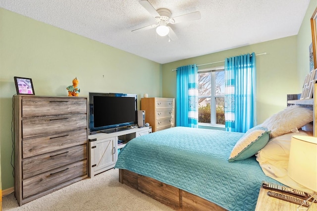 bedroom with a textured ceiling, ceiling fan, and light colored carpet