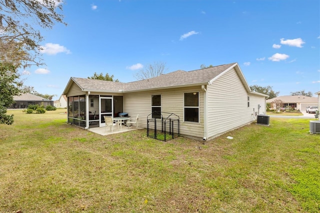 back of property featuring central AC unit, a patio, a sunroom, and a lawn