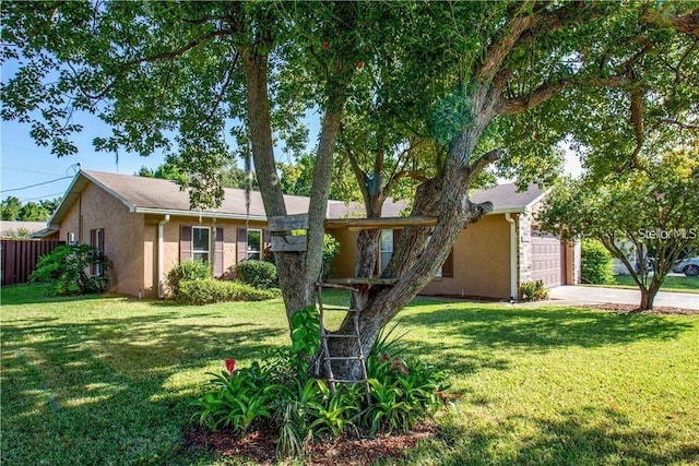 ranch-style house with an attached garage, a front lawn, and stucco siding