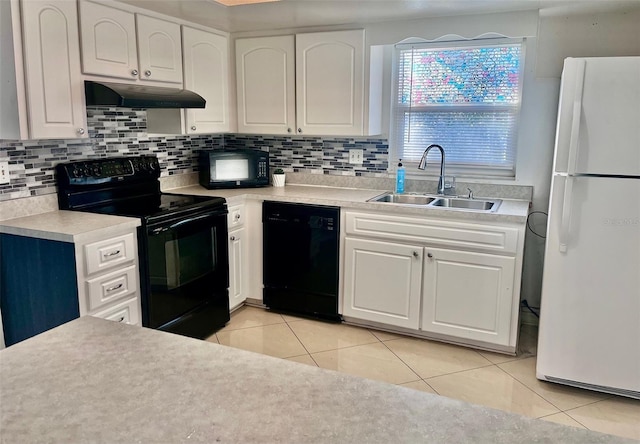 kitchen with sink, light tile patterned floors, black appliances, and white cabinets