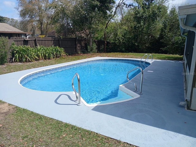 view of swimming pool featuring fence and a fenced in pool