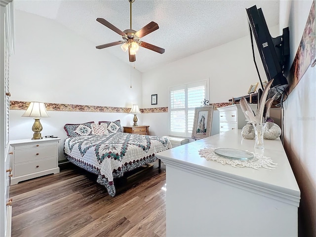 bedroom with lofted ceiling, wood-type flooring, a textured ceiling, and ceiling fan