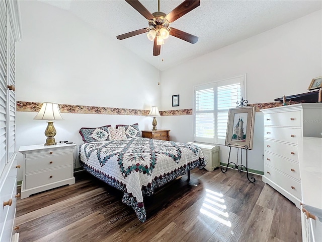 bedroom with ceiling fan, lofted ceiling, a textured ceiling, and dark hardwood / wood-style floors