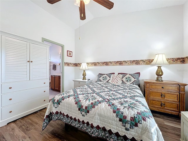 bedroom featuring vaulted ceiling, ensuite bath, ceiling fan, and dark hardwood / wood-style flooring