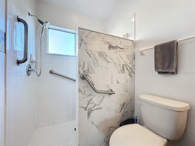 bathroom featuring toilet and a tile shower