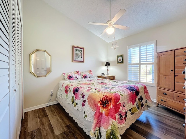 bedroom with lofted ceiling, dark hardwood / wood-style flooring, a textured ceiling, and ceiling fan