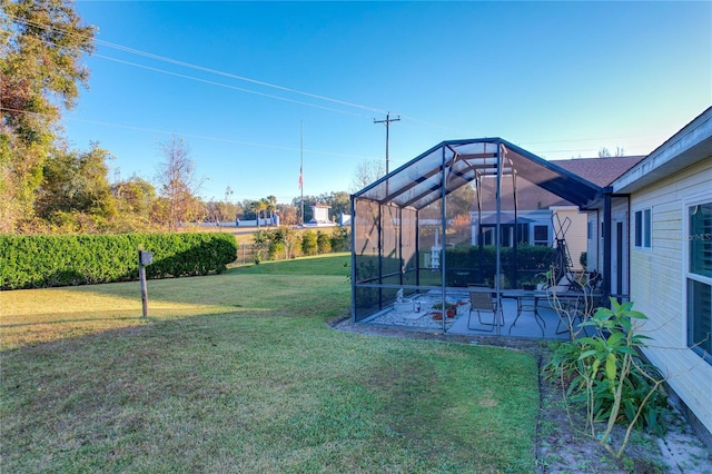 view of yard featuring a patio and glass enclosure