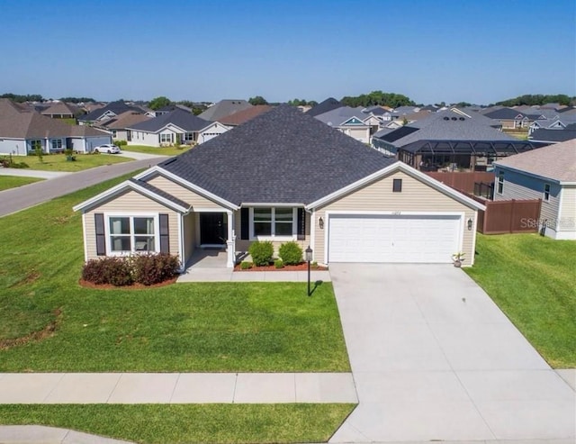 view of front of home with a front yard and a garage