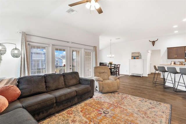 living room with ceiling fan, lofted ceiling, and dark hardwood / wood-style floors