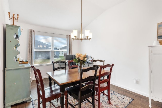 dining area with dark wood-type flooring, lofted ceiling, and a notable chandelier