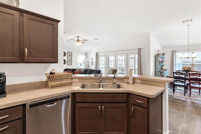 kitchen featuring lofted ceiling, stainless steel dishwasher, a wealth of natural light, sink, and ceiling fan with notable chandelier