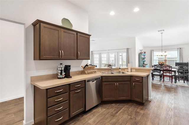 kitchen with decorative light fixtures, dark hardwood / wood-style floors, stainless steel dishwasher, sink, and a chandelier