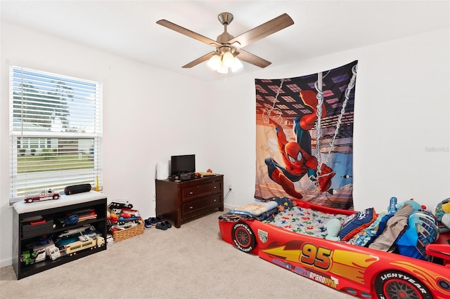 bedroom featuring ceiling fan and light carpet