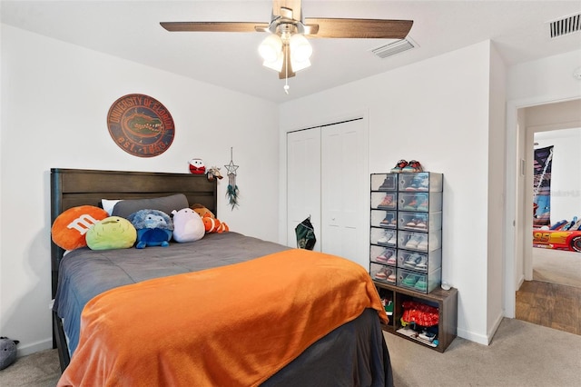 carpeted bedroom with ceiling fan and a closet