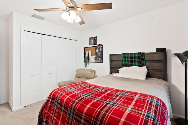 bedroom featuring ceiling fan, carpet, and a closet