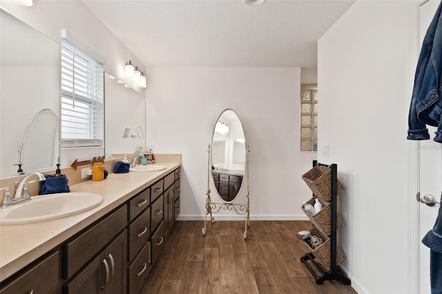 bathroom featuring a textured ceiling, hardwood / wood-style flooring, and vanity