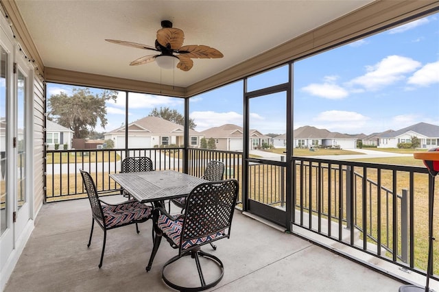 sunroom / solarium featuring ceiling fan