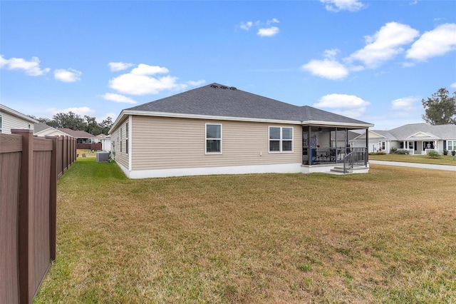 back of property featuring a lawn and central AC unit