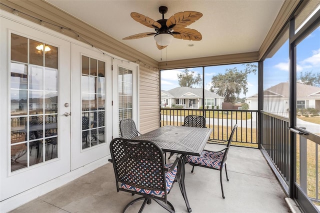 sunroom featuring ceiling fan