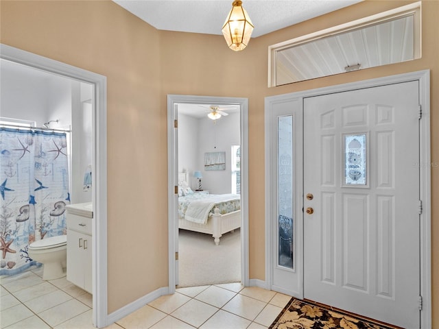 tiled entrance foyer with ceiling fan