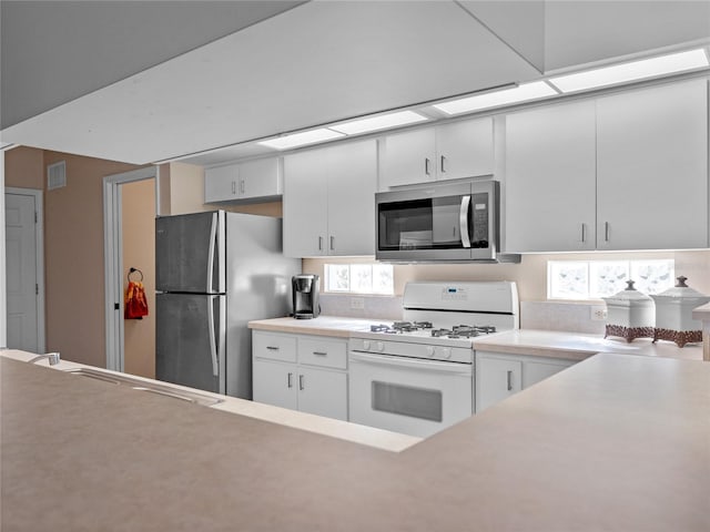 kitchen featuring sink, white cabinetry, and appliances with stainless steel finishes