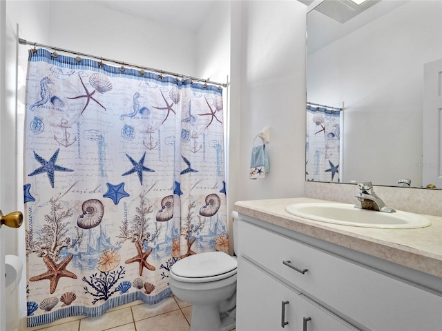 bathroom with toilet, vanity, tile patterned floors, and walk in shower