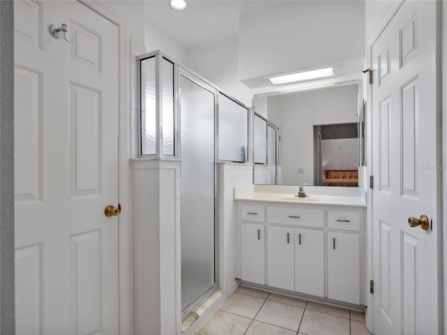 bathroom with tile patterned floors, vanity, and a shower with shower door