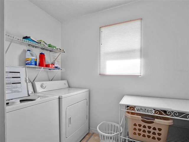 clothes washing area with washer and clothes dryer