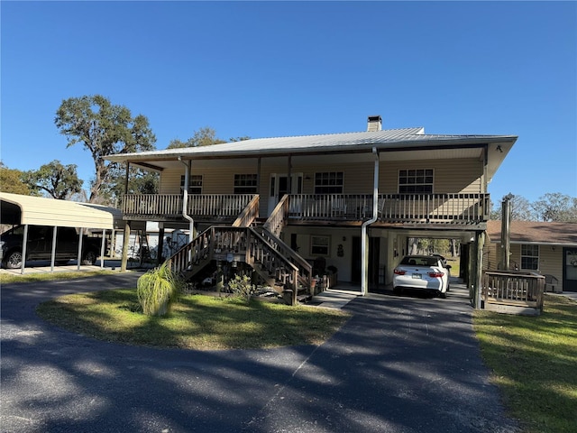 view of front of property with a porch and a carport