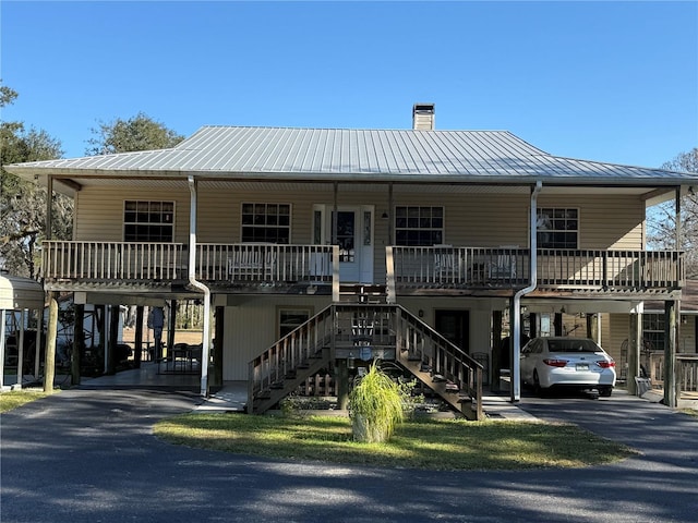 view of front of house with a porch and a carport