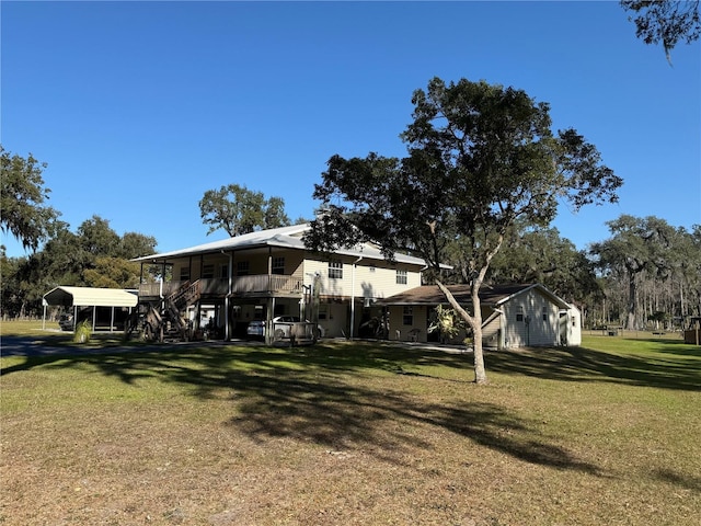 back of property featuring a yard and a carport