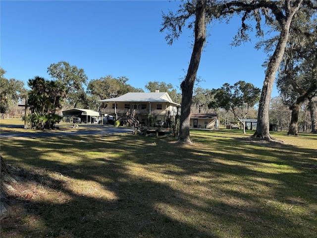 view of yard with a porch and a carport