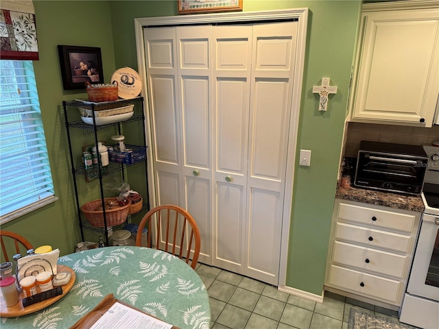 tiled dining room with a healthy amount of sunlight