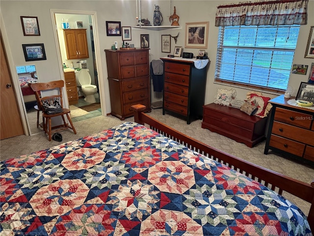 carpeted bedroom with ensuite bath