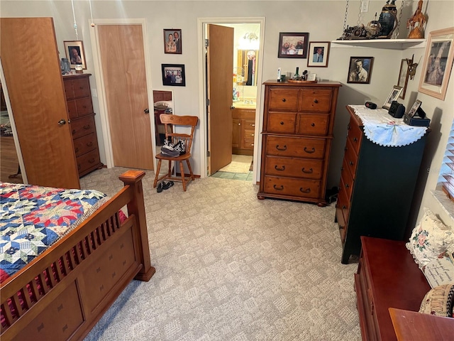 carpeted bedroom featuring ensuite bathroom