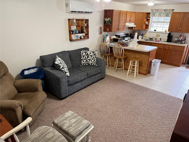 living room featuring sink, a wall unit AC, and light tile patterned floors