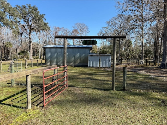 view of yard with an outbuilding and a rural view