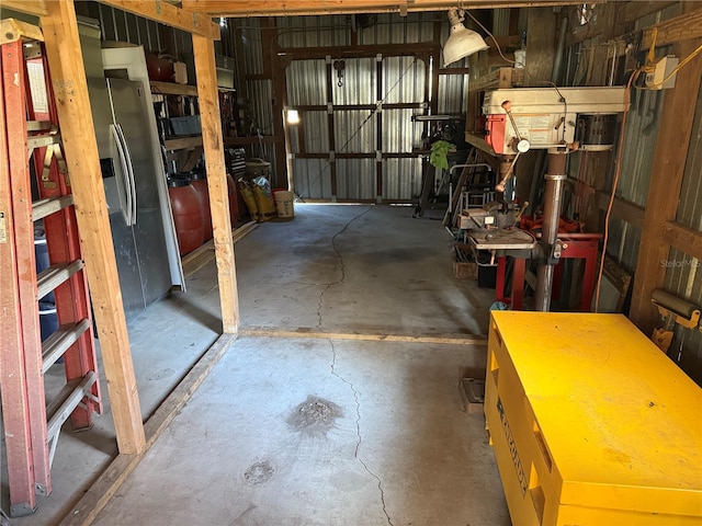 garage featuring stainless steel refrigerator with ice dispenser