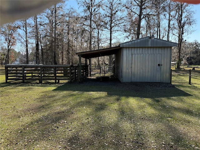 view of outbuilding with a yard