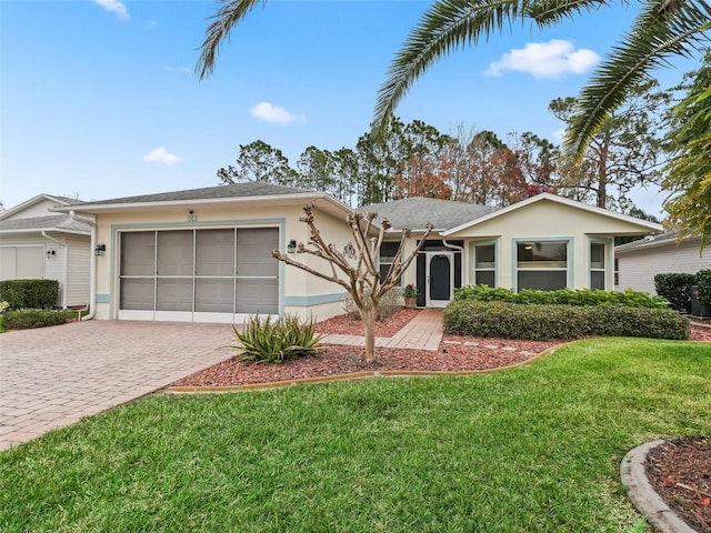 ranch-style house featuring a garage and a front lawn