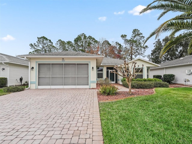 single story home with a garage and a front lawn