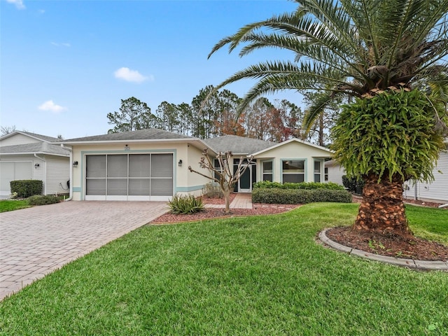 ranch-style house with a garage and a front lawn