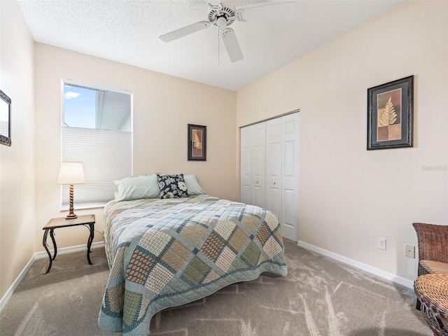 carpeted bedroom featuring ceiling fan and a closet