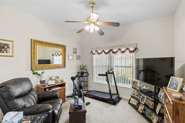 exercise area with ceiling fan and carpet